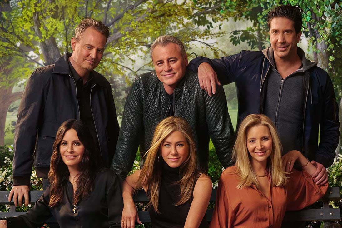 The cast of friend huddle around a couch for the reunion special